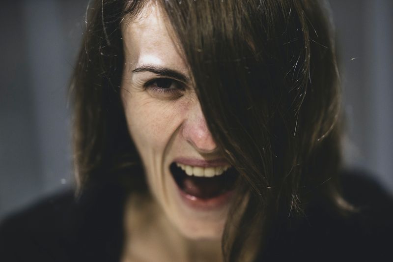 Close up of a woman screaming.
