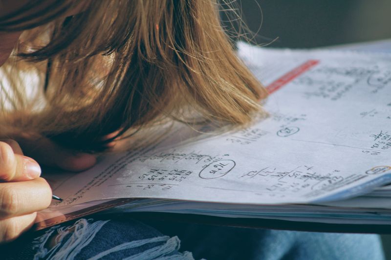 Person writing in a notebook.