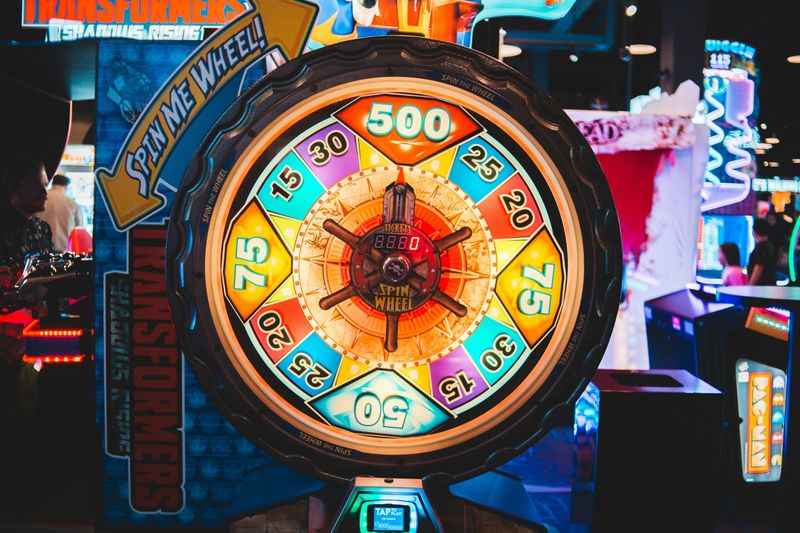 A colorful spinning wheel game in an arcade.