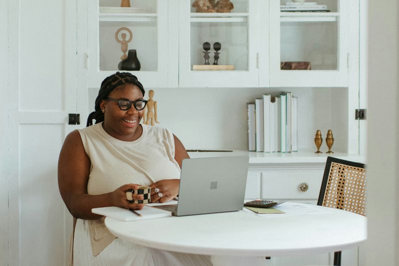 A woman looking at her laptop.
