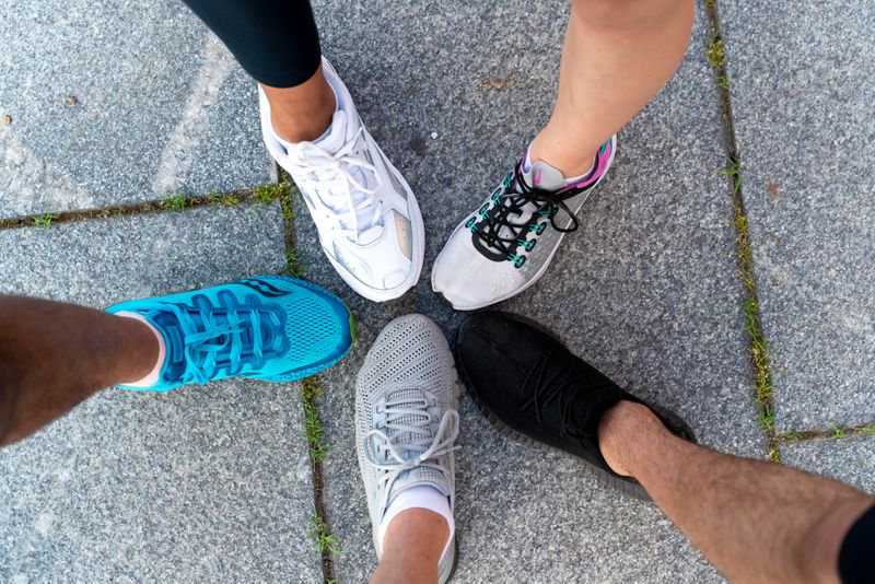 Close up of male and female legs wearing running shoes