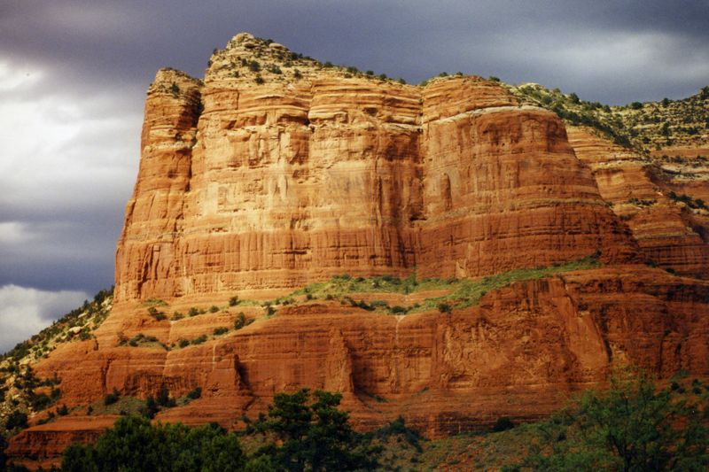 A mountain face showing sedimentary rock, the second step in the rock cycle diagram.