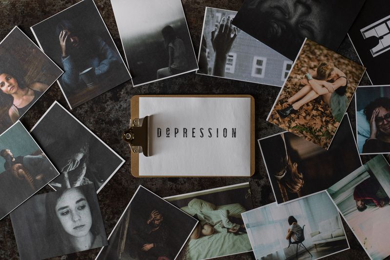 Clipboard with the word 'depression', surrounded by photos of sad people.