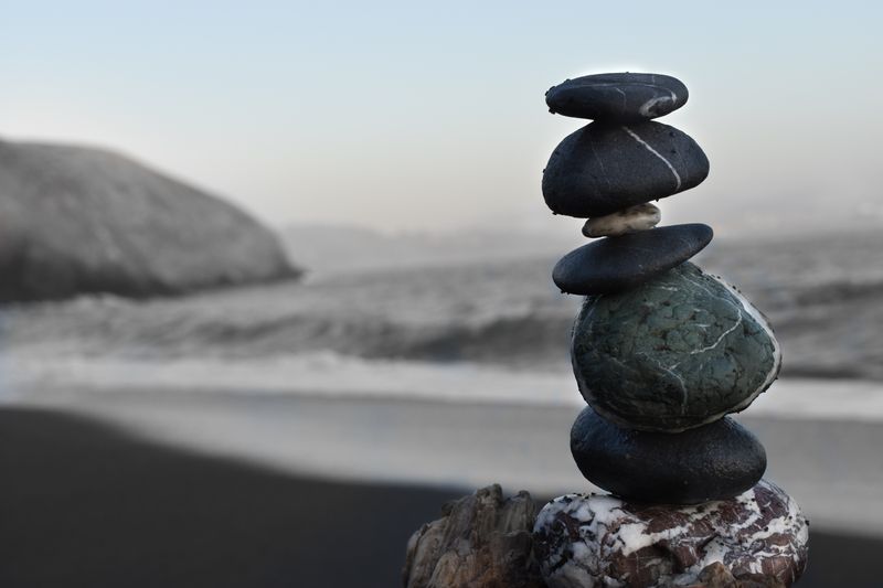 Small rocks stacked on each other in a balancing act.