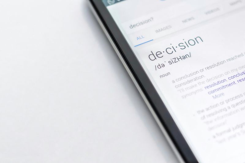 A tablet open to a dictionary definition of "decision".