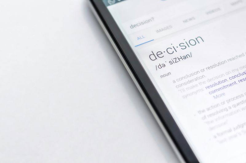 A tablet open to a dictionary definition of 'decision'.