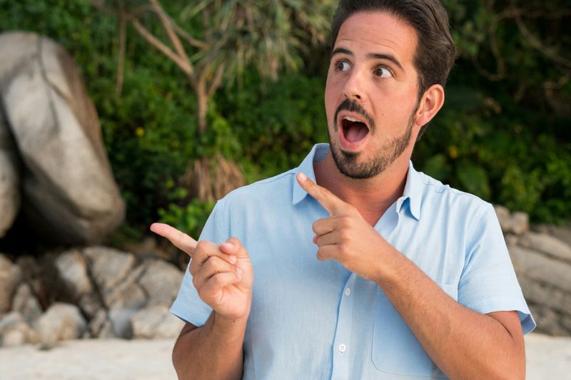 A man pointing his fingers.