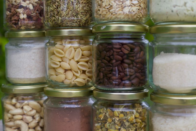 Image of multiple glass jars filled with dry foods, stacked one on top of the other.