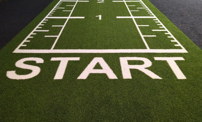 The word start written in capital letters across a strip of green grass.