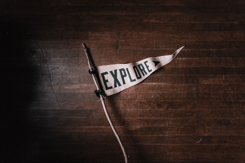 a stick with a pennant tied to it that read, 'Explore'