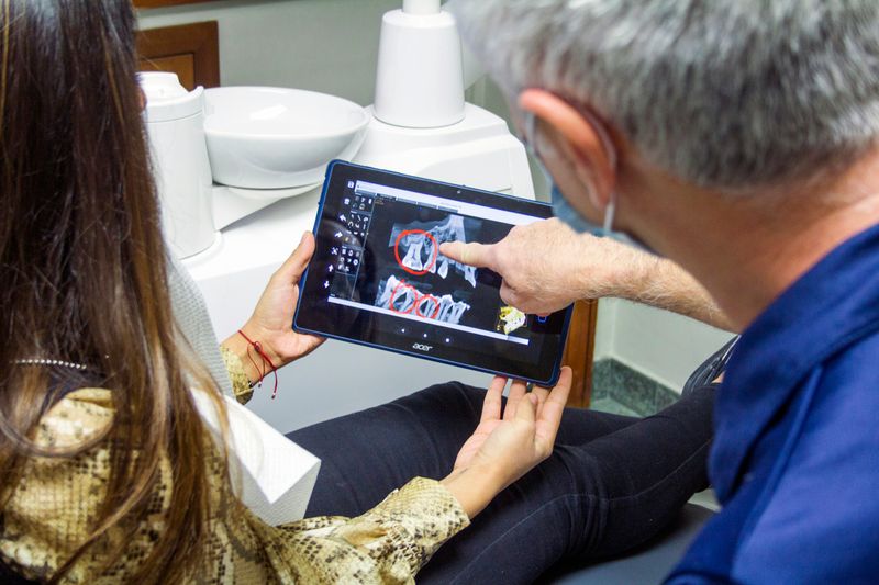 A patient and doctor look at medical imaging together. 