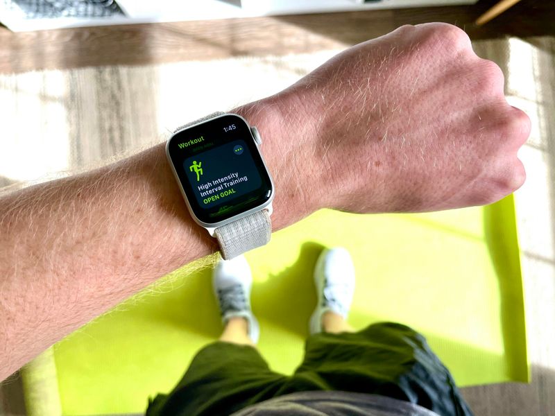 A person looks at their fitness tracking watch as they exercise.