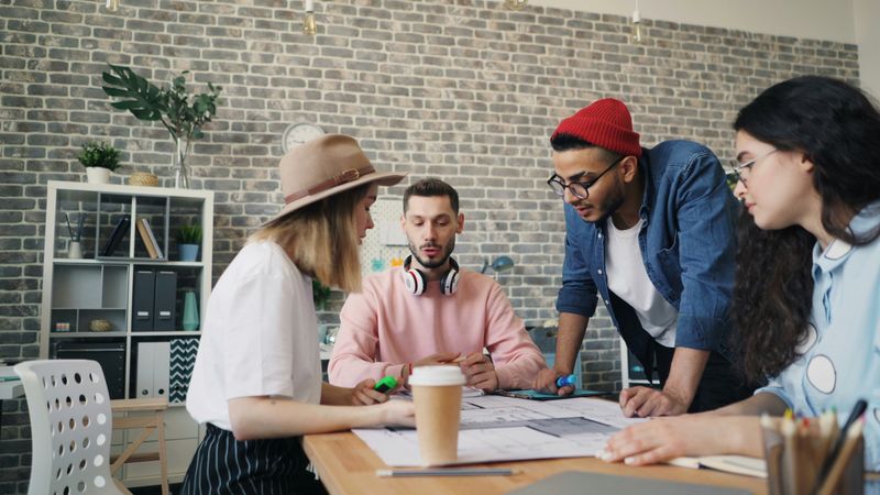 A diverse group of young employees in an office meeting.