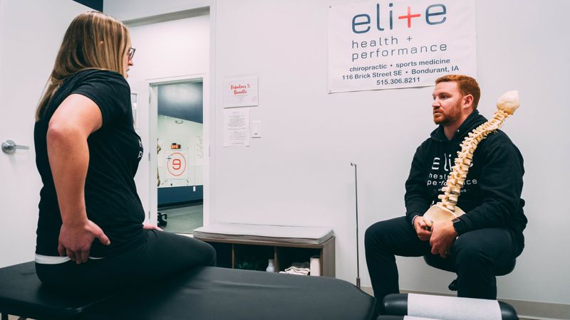 Woman patient talking to a man chiropractor