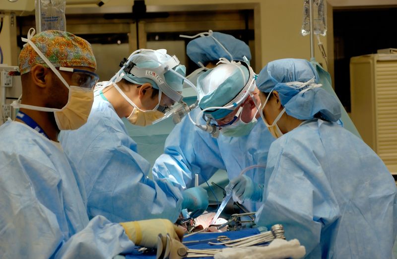 Surgeons working tirelessly on a patient.