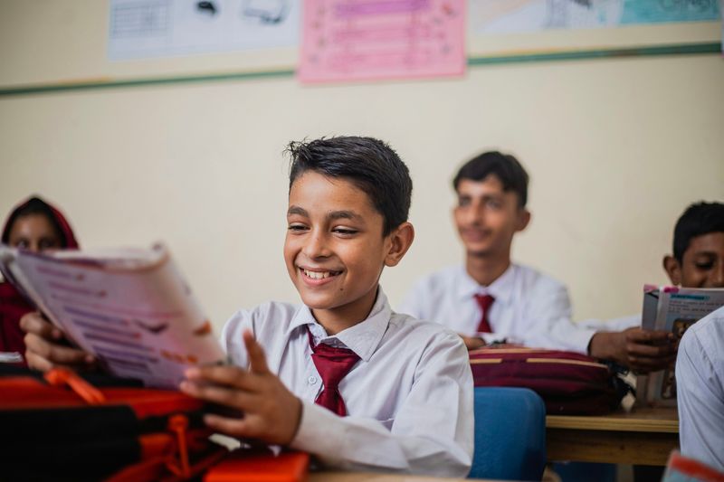 Young students sitting at desks in a classroom.