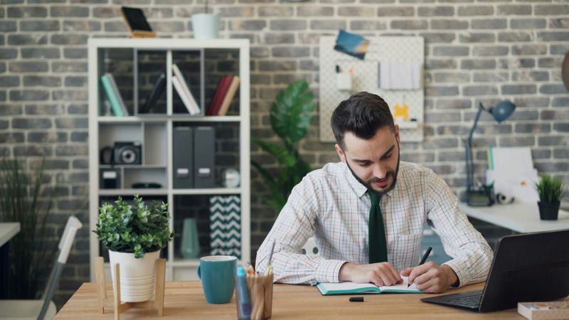 A man working at an office table.