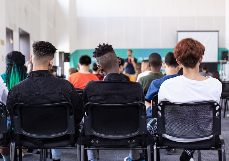 A row of students learning at school.