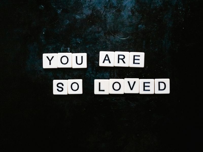 White Scrabble tiles on a black background read