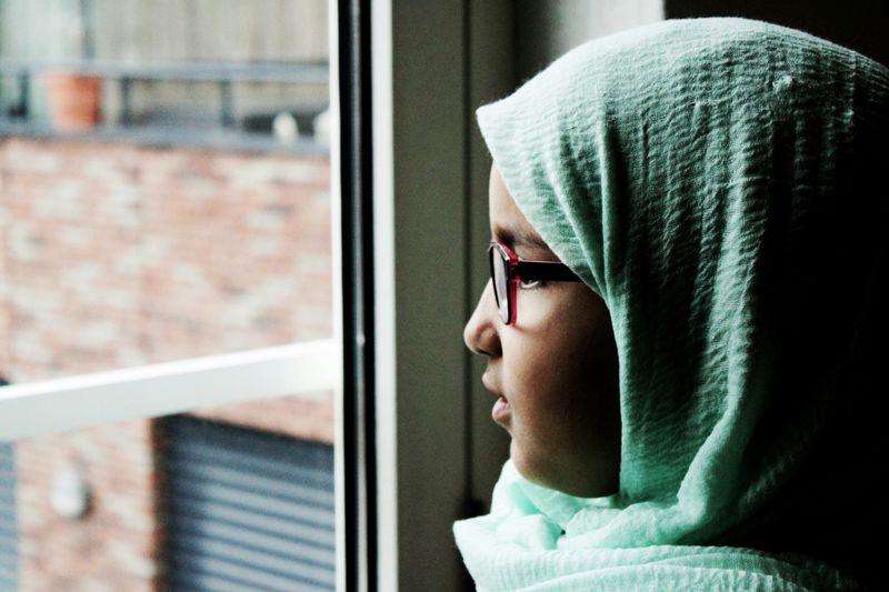 Student staring out a window