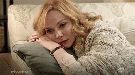 Actor Christina Hendricks, crying, laying her head on a pillow