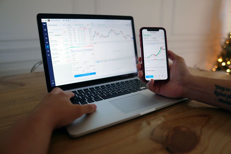 computer and phone with unreadable graphs and charts.