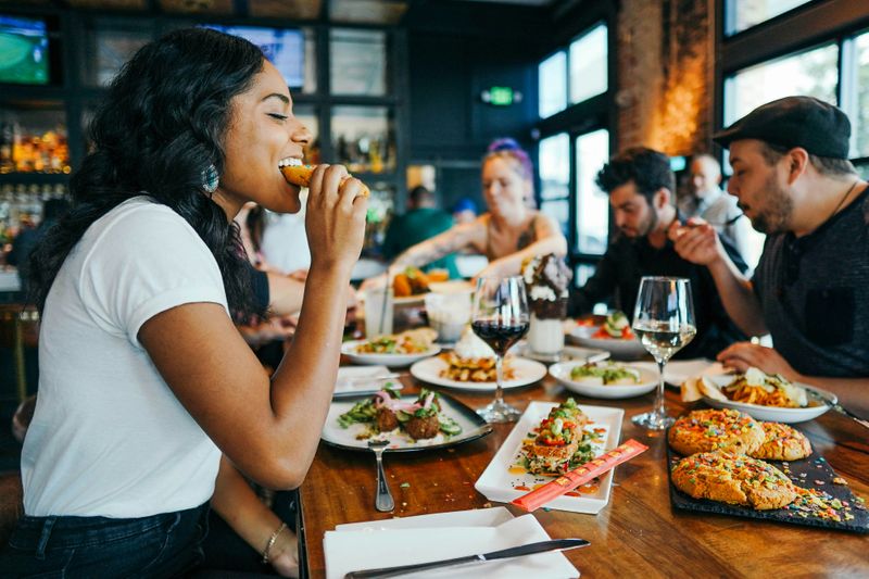 A group of friends eating at a restaurant.