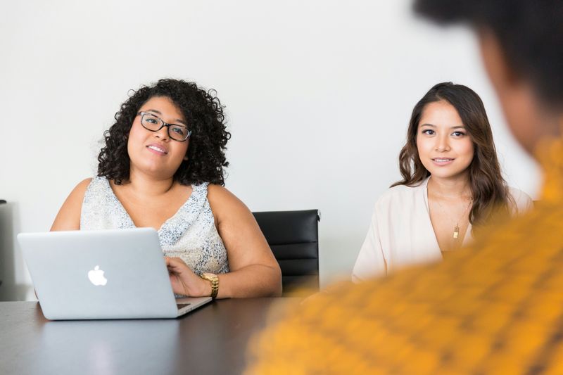 Image of person facing two women in job interview