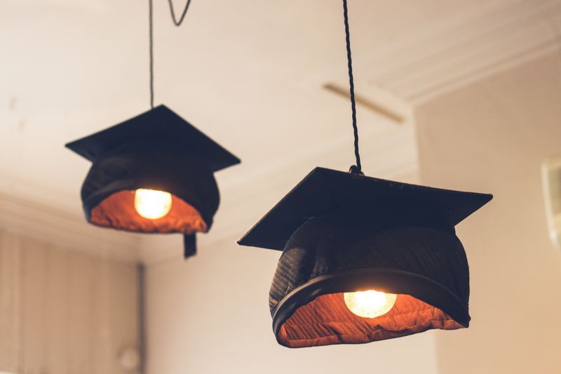 Graduation caps on light bulbs.