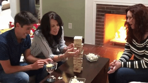 Group of people playing with Jenga blocks.