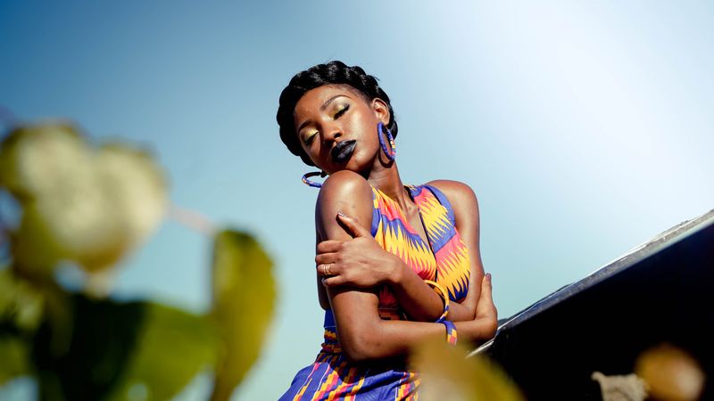 An African American woman hugging herself.