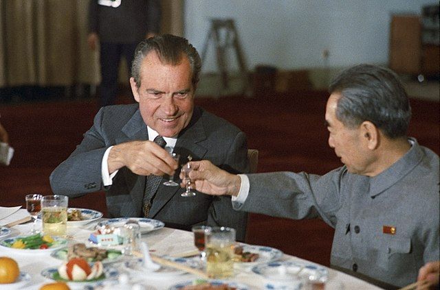 Nixon and and a Chinese official sharing a drink together at a state function.