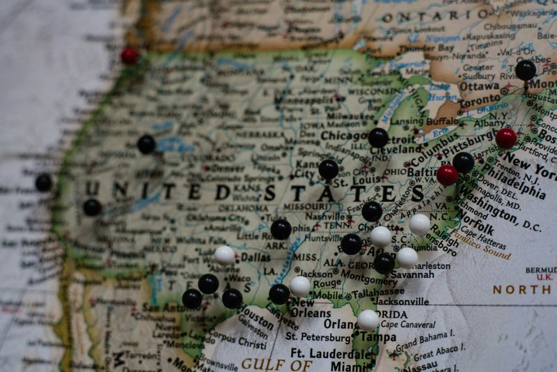 A map of the United States with pins on different cities.