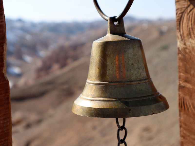 A golden bell with a dangling handle.