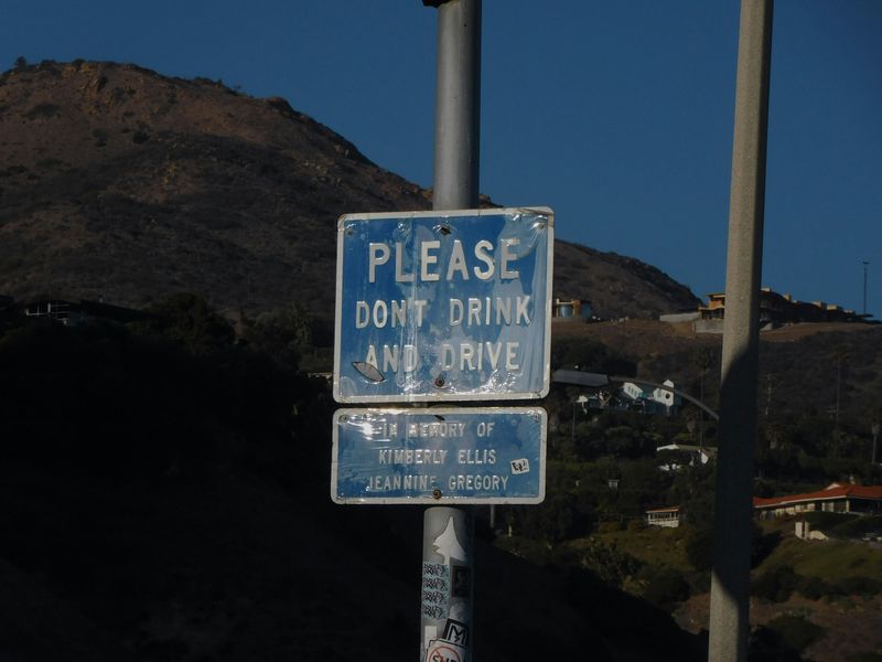 A sign reads: Please Don't Drink AND Drive, Dedicated In Memory of Kimberly Ellis Jeannine Gregory.