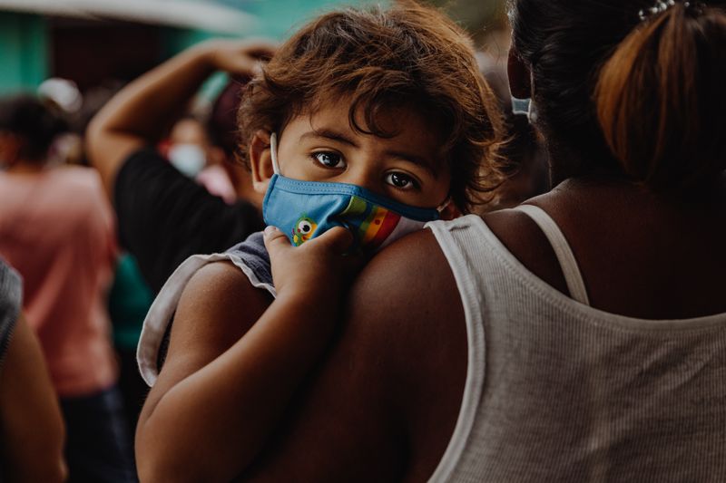 kid with covid mask