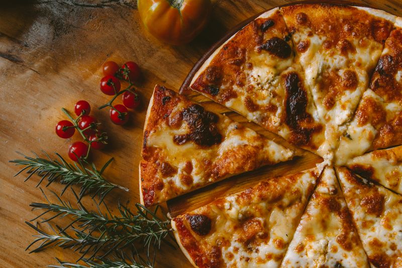 Cheese pizza with a slice removed from it.