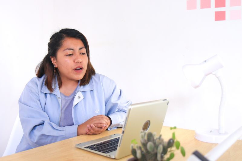 young woman speaking to a laptop during a video interview