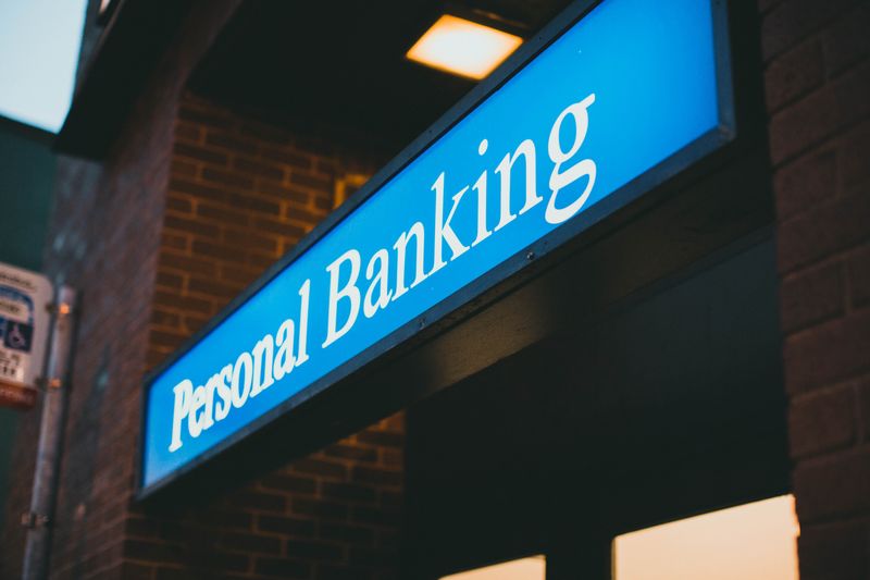 A sign in front of a building that reads 'Personal Banking'.