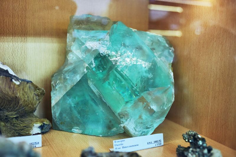 A big green piece of fluorite in a display case. 