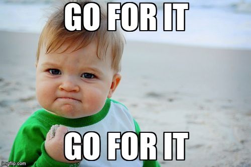 A baby holding up a fist. The text reads, 'Go for it'