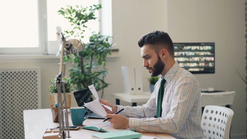 A man preparing for job interview with documents.