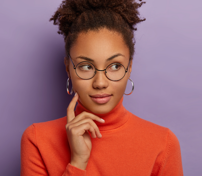 A thoughtful African American woman with her finger on her cheek