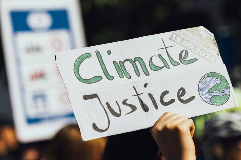 A protest sign on cardboard, with a hand drawn Planet Earth, and the phrase 