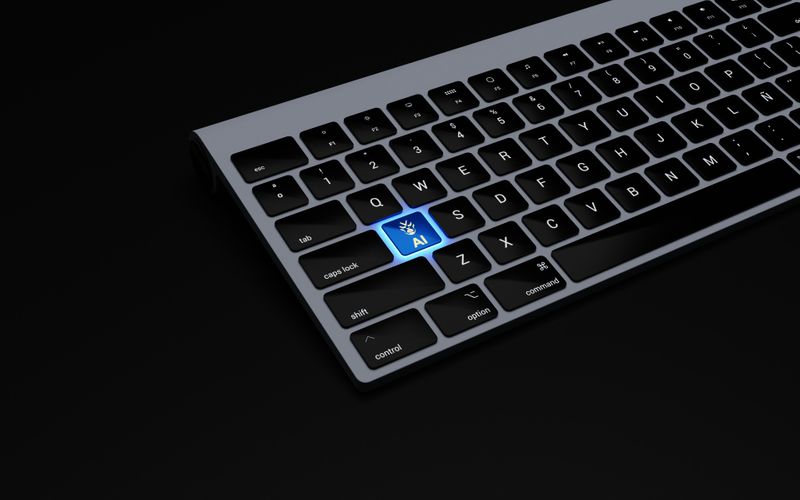 A close-up image of a computer keyboard with an 'AI' key replacing the usual 'A'. A blue light glows around this 'AI' key. 