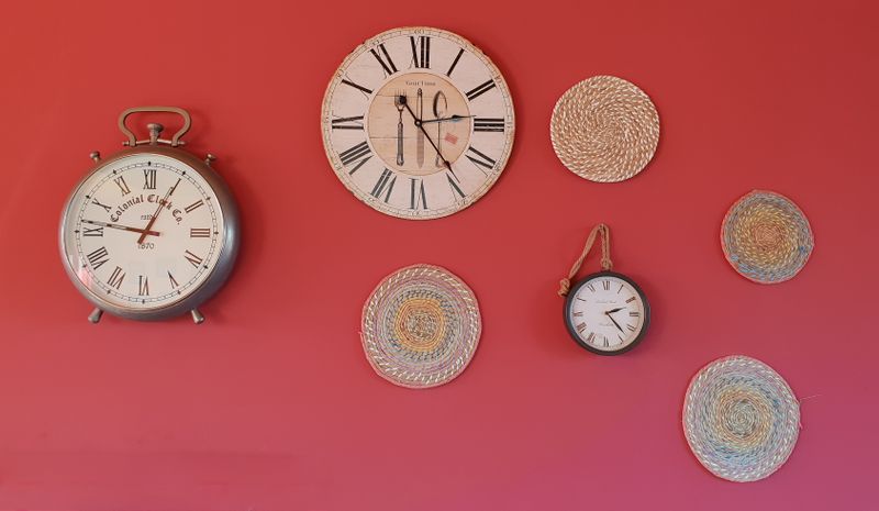 A series of clocks on a wall.