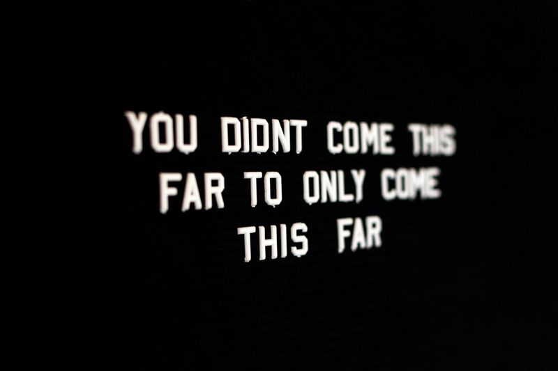 White text on a black surface that reads 'YOU DIDN'T COME THIS FAR TO ONLY COME THIS FAR'.