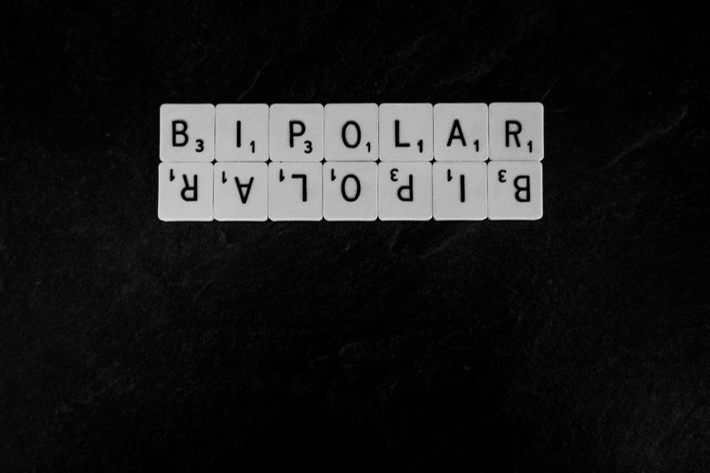 Black square with Scrabble tiles spelling out Bipolar.