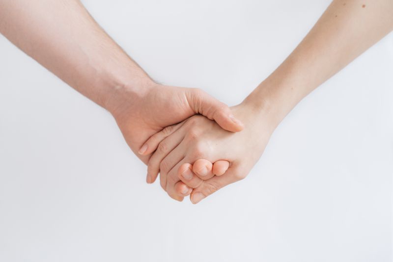 Two people holding hands