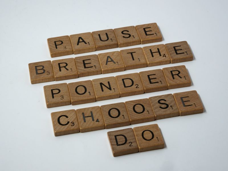 Scrabble tiles with the words: pause, breathe, ponder, choose, do.